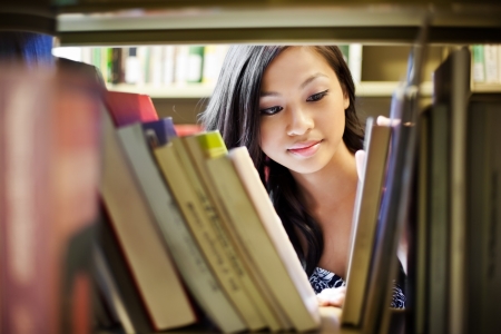 Woman looking through bookshelf 