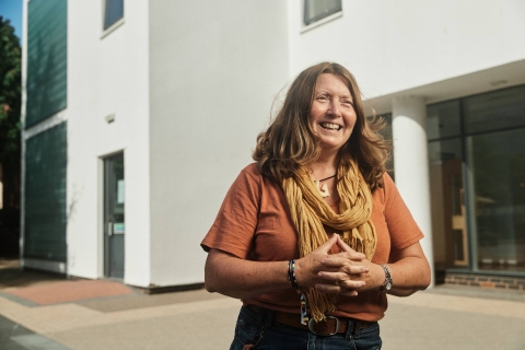 Postgraduate research student smiling on campus