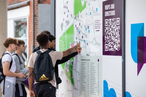 Visiting students looking at large campus map to help navigate  - Open Day 2023